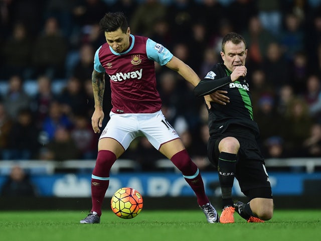 Mauro Zarate of West Ham United and Glenn Whelan of Stoke City compete for the ball during the Barclays Premier League match between West Ham United and Stoke City at the Boleyn Ground on December 12, 2015
