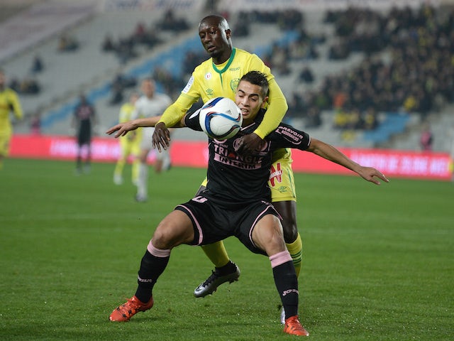 Nantes' French defender Youssouf Sabaly (up) vies with Toulouse's French forward Wissam Ben Yedder during the French Ligue 1 football match between FC Nantes and Toulouse FC at the La Beaujoire stadium in Nantes on December 12, 2015.