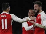 Olivier Giroud celebrates with Arsenal teammates Mesut Ozil and Theo Walcott after scoring against Manchester City in the Premier League on December 21, 2015