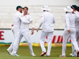 Dale Steyn celebrates with teammates after claiming the wicket of Alex Hales on day one of the first Test between South Africa and England on December 26, 2015