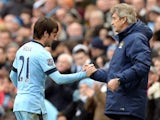 Manchester City's David Silva and Manuel Pellegrini as the player is substituted off against Crystal Palace on December 20, 2014