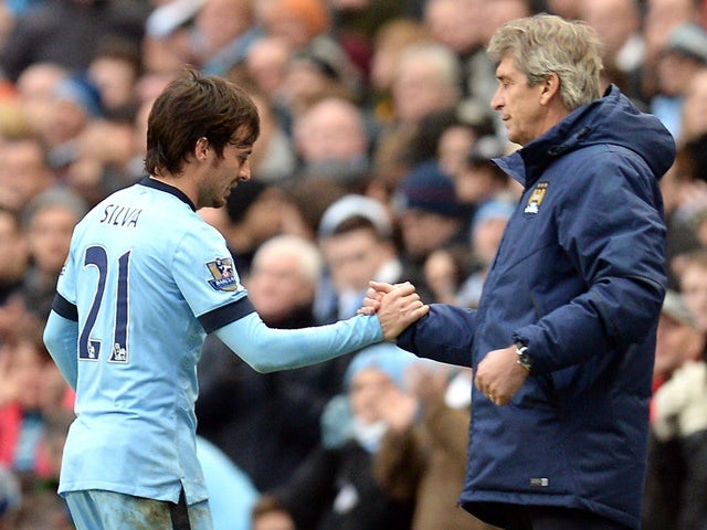 Manchester City's David Silva and Manuel Pellegrini as the player is substituted off against Crystal Palace on December 20, 2014