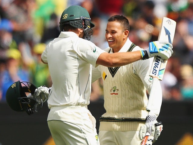 Joe Burns and Usman Khawaja of Australia celebrate on day one of the second Test against the West Indies in Melbourne on December 26, 2015