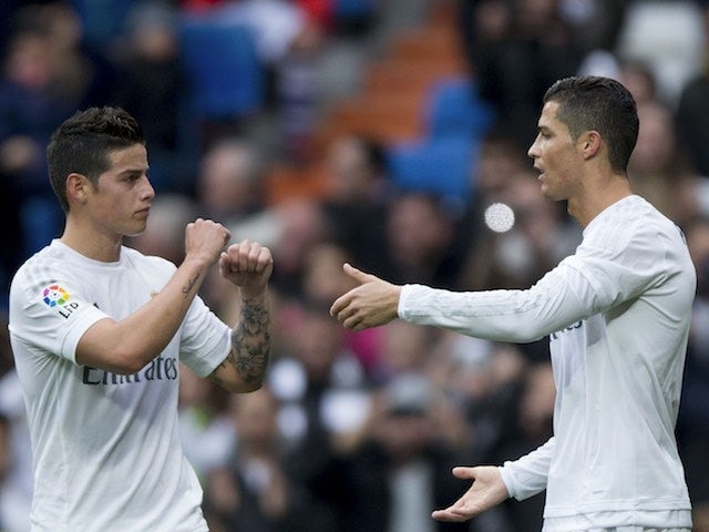 James Rodriguez congratulates Cristiano Ronaldo for scoring the opener during the game between Real Madrid and Real Sociedad on December 30, 2015