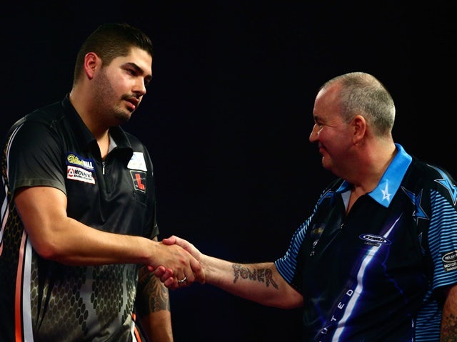Jelle Klaasen shakes hands with Phil Taylor after beating him at the PDC World Darts Championships on December 30, 2015