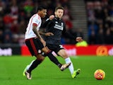 Patrick van Aanholt and Adam Lallana in action during the game between Sunderland and Liverpool on December 30, 2015