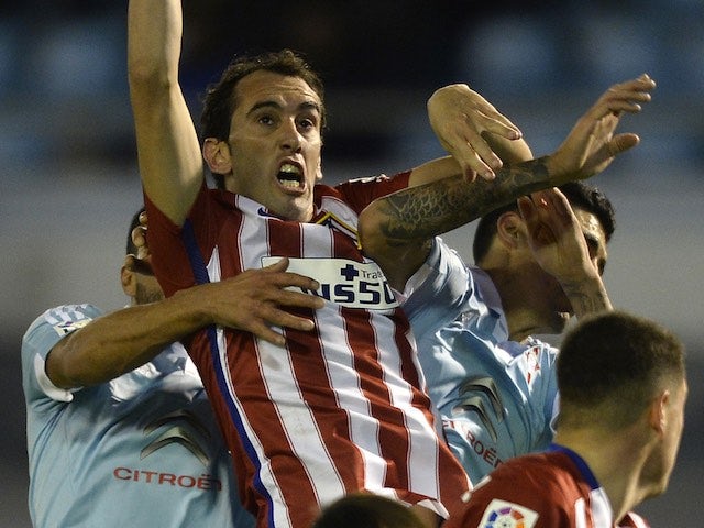Diego Godin is violated from all angles during the game between Celta Vigo and Atletico Madrid on January 10, 2016