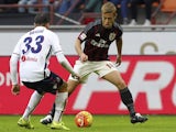 Keisuke Honda and Matteo Brighi in action during the game between AC Milan and Bologna on January 6, 2016