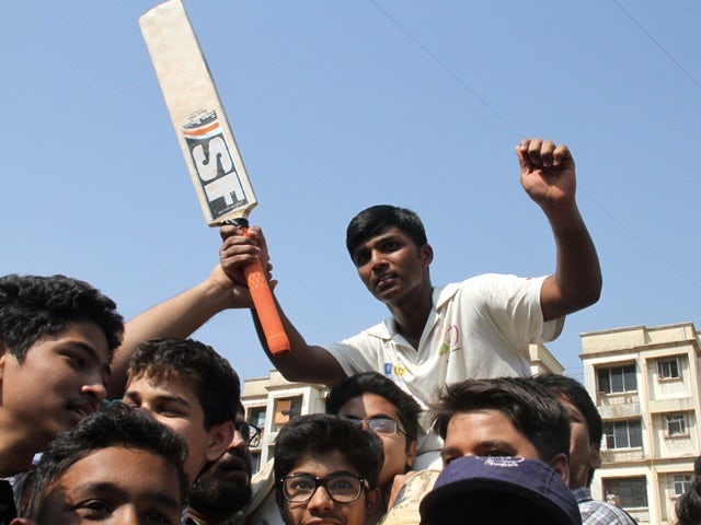 Pranav Dhanawade celebrates smashing a 117-year-old record for the highest number of runs scored in one innings in Mumbai on January 5, 2016