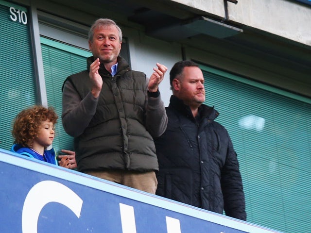 Chelsea owner Roman Abramovich applauds from the stand the FA Cup third-round match against Scunthorpe United at Stamford Bridge on January 10, 2016