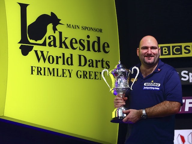 Scott Waites poses with his trophy after winning at the World Professional Darts Championships on January 10, 2016