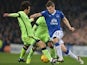 Everton's Seamus Coleman takes on Manchester City's David Silva (L) during the League Cup semi-final first leg at Goodison Park on January 6, 2016