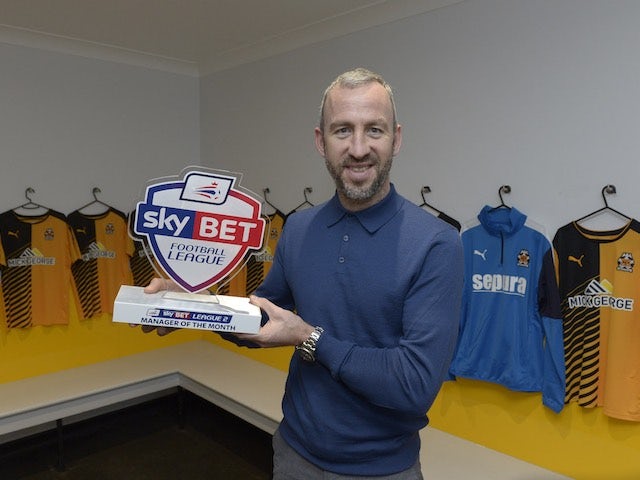 Shaun Derry poses with his Manager of the Month award for December 2015