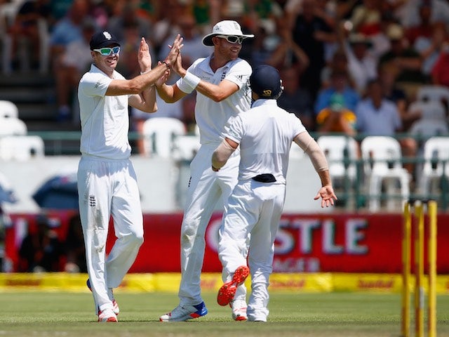 Stuart Broad and James Anderson celebrate taking the wicket of AB de Villiers on day three of the second Test between South Africa and England on January 4, 2016