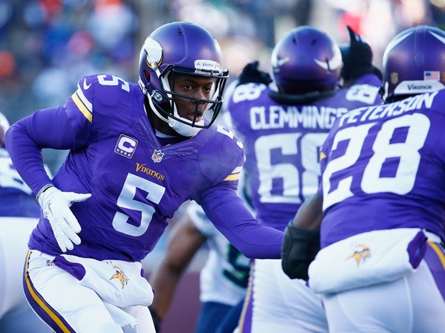 Teddy Bridgewater of the Minnesota Vikings hands the ball off to Adrian Peterson in the first quarter against the Seattle Seahawks on January 10, 2016