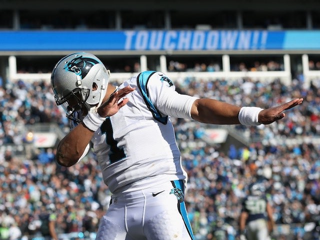 A visibly cold Cam Newton celebrates during the game between Seattle Seahawks and Carolina Panthers on January 17, 2016