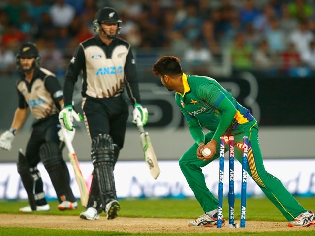 Imad Waseem of Pakistan runs out Martin Guptill of New Zealand during the first T20 match at Eden Park on January 15, 2016 