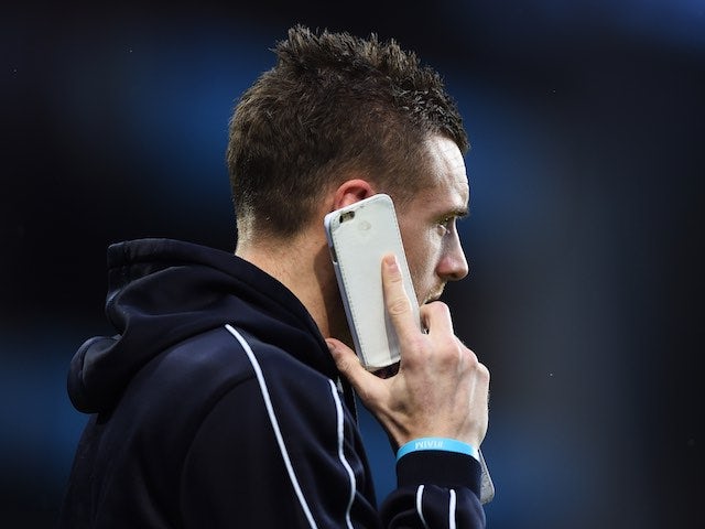 Jamie Vardy fields a call from Ridley Scott prior to the game between Aston Villa and Leicester on January 16, 2016