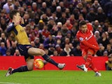 Roberto Firmino of Liverpool scores his team's first goal against Arsenal at Anfield on January 13, 2016