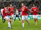 Wayne Rooney celebrates with teammates as he scores Manchester United's first goal from the penalty spot during the Premier League match against Newcastle United at St James' Park on January 12, 2016 