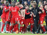 Adam Lallana celebrates with Liverpool teammates and manager Jurgen Klopp after scoring the winner against Norwich City on January 23, 2016