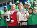 Barney Corkhill and Kim Clijsters pose with the trophies on day one of the Australian Open on January 18, 2016
