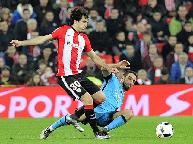 Athletic Bilbao's Inigo Lekue vies with Barcelona's Arda Turan on January 20, 2016