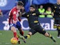 Luciano Vietto is tackled by Ever Banega during the La Liga match between Atletico Madrid and Sevilla on January 24, 2016