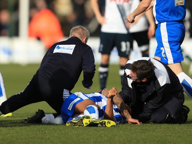 Alex Wynter of Colchester United receives the medical treatment before being stretched off during the FA Cup fourth-round match against Tottenham Hotspur on January 30, 2016