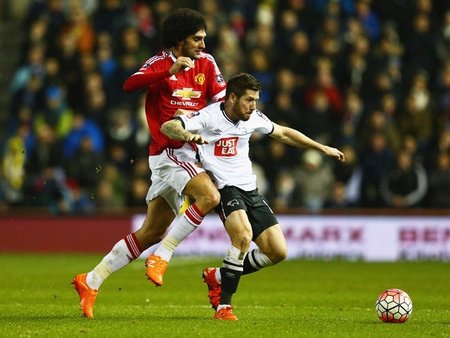 Jacob Butterfield and Marouane Fellaini in action during the FA Cup fourth-round match between Derby County and Manchester United at iPro Stadium on January 29, 2016