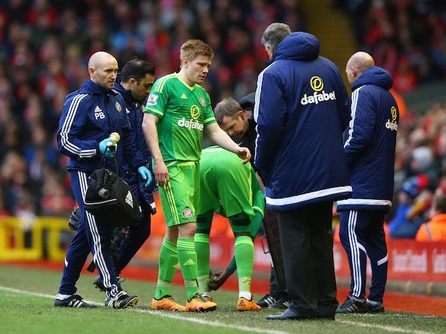 An injured Duncan Watmore walks off the pitch during the Premier League game between Liverpool and Sunderland on February 6, 2016