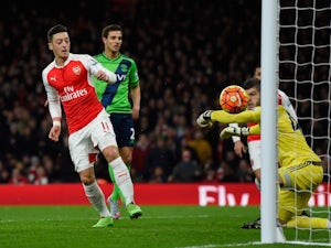 Mesut Ozil has a shot saved by Fraser Forster during the Premier League game between Arsenal and Southampton on February 2, 2016