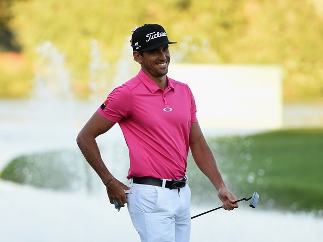 Rafael Cabrera-Bello smiles after his birdie on the 18th hole during the second round of the Omega Dubai Desert Classic at the Emirates Golf Club on February 5, 2016