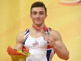 Sam Oldham poses on the podium with his silver medal for the horizontal bar event during the European Men's Artistic Gymnastics Individual Championships in Montpellier on April 19, 2015