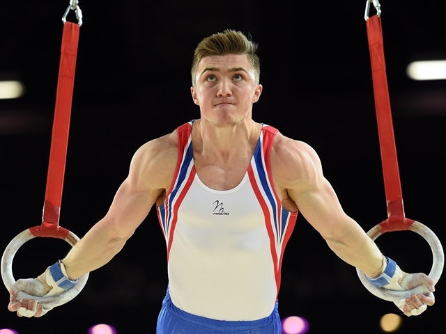 Sam Oldham competes in a qualifying round of the rings event of the European Men's Artistic Gymnastics Championships on April 16, 2015