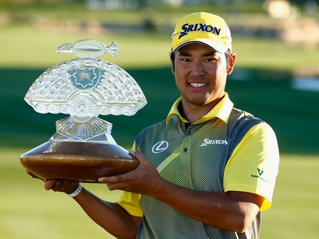 Hideki Matsuyama  poses with the winners trophy on the 18th hole of the Waste Management Phoenix Open at TPC Scottsdale on February 7, 2016
