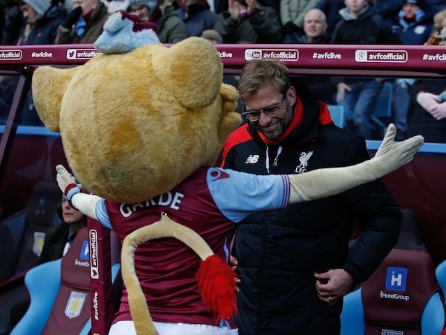 Jurgen Klopp receives a hug from Hercules The Lion ahead of the Premier League game between Aston Villa and Liverpool on February 14, 2016