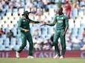 South African bowler Kagiso Rabada and fielder Hashim Amla celebrate the dismissal of England batsman Alex Hales on February 9, 2016