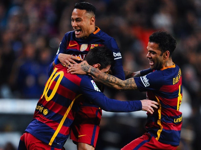 Lionel Messi celebrates with his teammates Neymar and Dani Alves after scoring the opening goal during the La Liga match between Barcelona and Celta Vigo on February 14, 2016