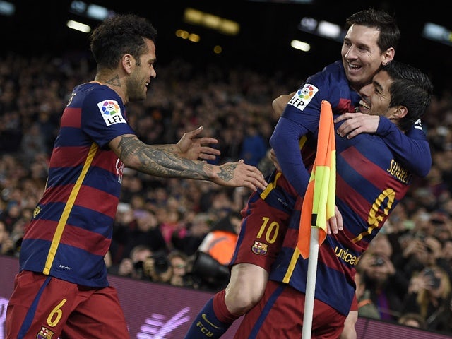 Barcelona's Luis Suarez celebrates a goal with Lionel Messi and Dani Alves during the match against Celta Vigo on February 14, 2016