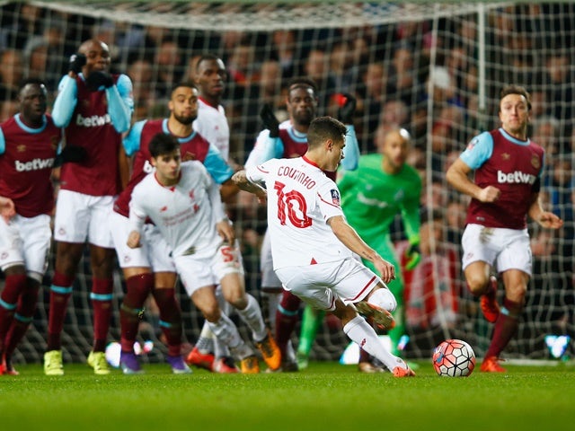 Philippe Coutinho of Liverpool scores their first and equalising goal from a free kick during the FA Cup fourth-round replay against West Ham United on February 9, 2016