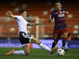 Santi Mina takes on Adriano during the Copa del Rey semi between Valencia and Barcelona on February 10, 2016