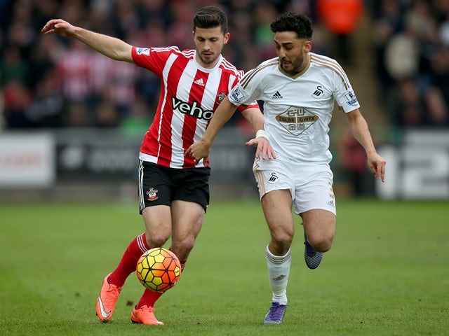 Shane Long of Southampton and Neil Taylor of Swansea City compete for the ball on February 13, 2016