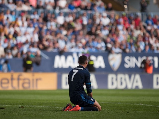 Cristiano Ronaldo goes down on his knees after missing a penalty during the La Liga game between Malaga and Real Madrid on February 20, 2016