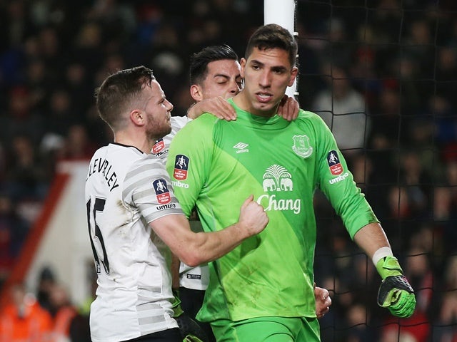 Joel Robles of Everton is congratulated by teammates Tom Cleverley and Ramiro Funes Mori after stopping a penalty kick during the FA Cup fifth-round match against Bournemouth on February 20, 2016 