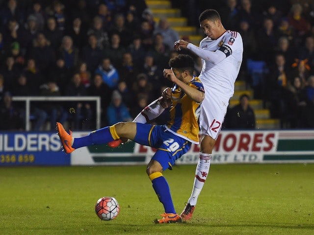 Chris Smalling shoots past Nat Knight-Percival during the FA Cup game between Shrewsbury Town and Manchester United on February 22, 2016