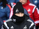 Francesco Guidolin attempts to go unnoticed during the Premier League game between Tottenham Hotspur and Swansea City on February 28, 2016