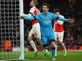 Lionel Messi celebrates scoring the opener during the Champions League game between Arsenal and Barcelona on February 22, 2016
