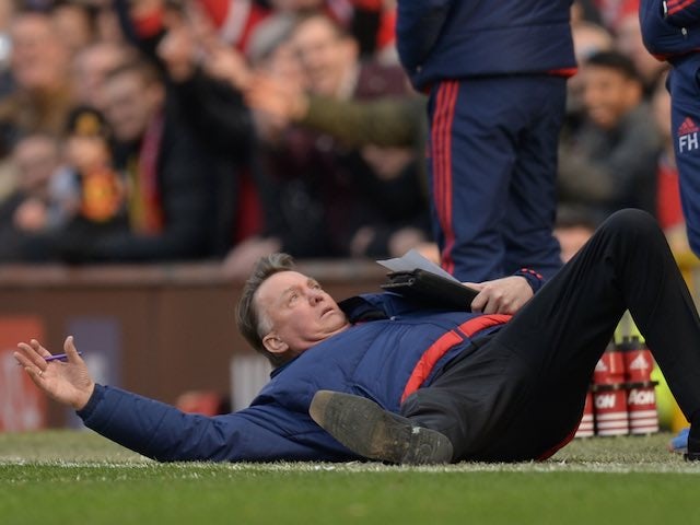 Louis van Gaal dives to the ground during the Premier League game between Manchester United and Arsenal on February 28, 2016