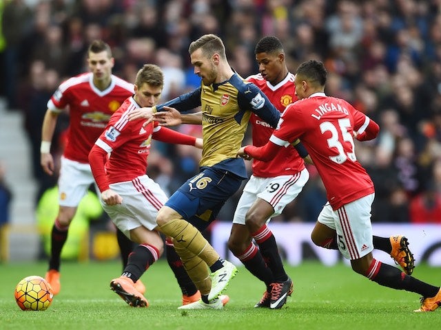 Marcus Rashford goes after Aaron Ramsey during the Premier League game between Manchester United and Arsenal on February 28, 2016